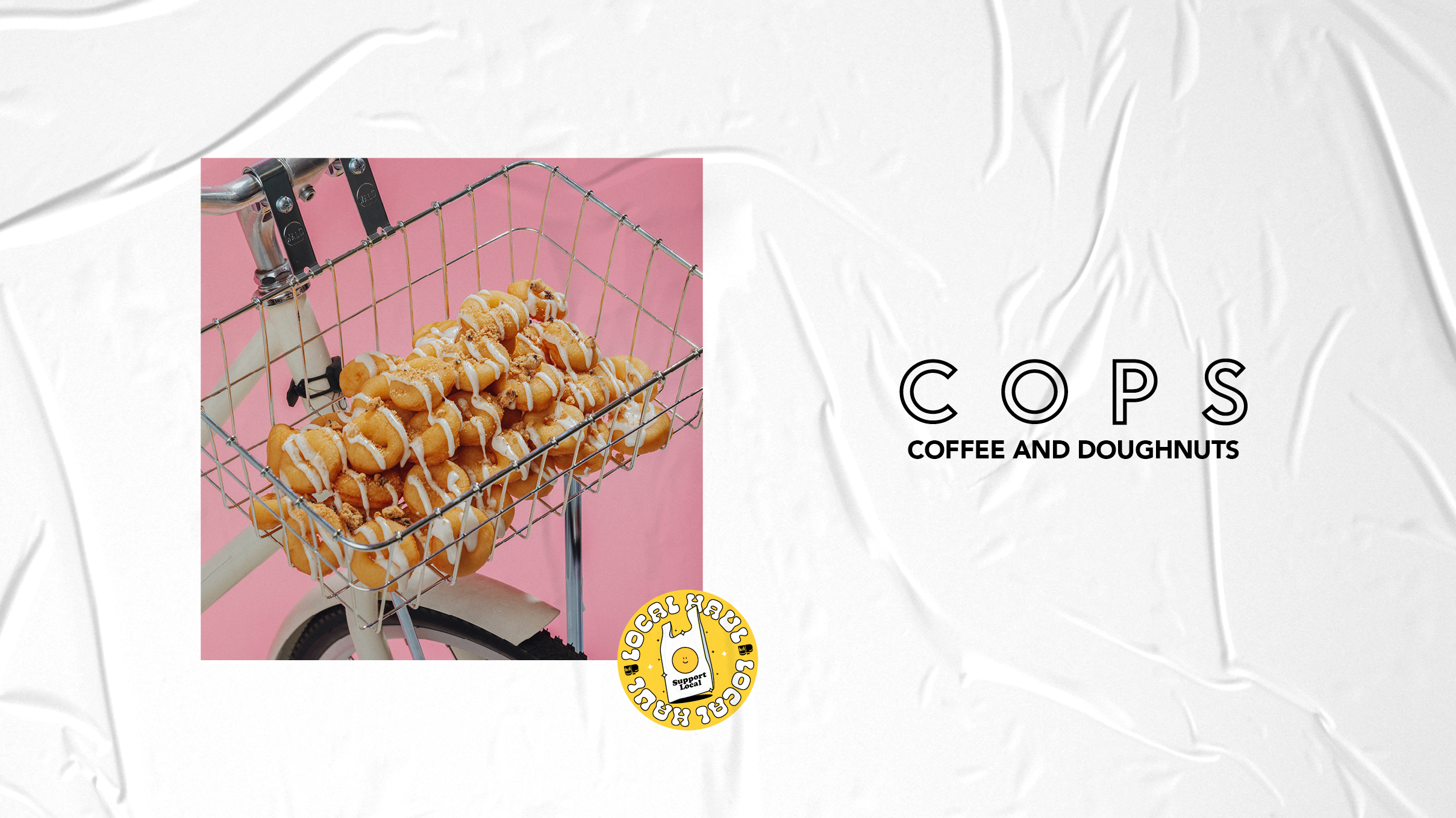 Donuts with icing inside a bicycle rack from Cops Coffee and Doughnuts